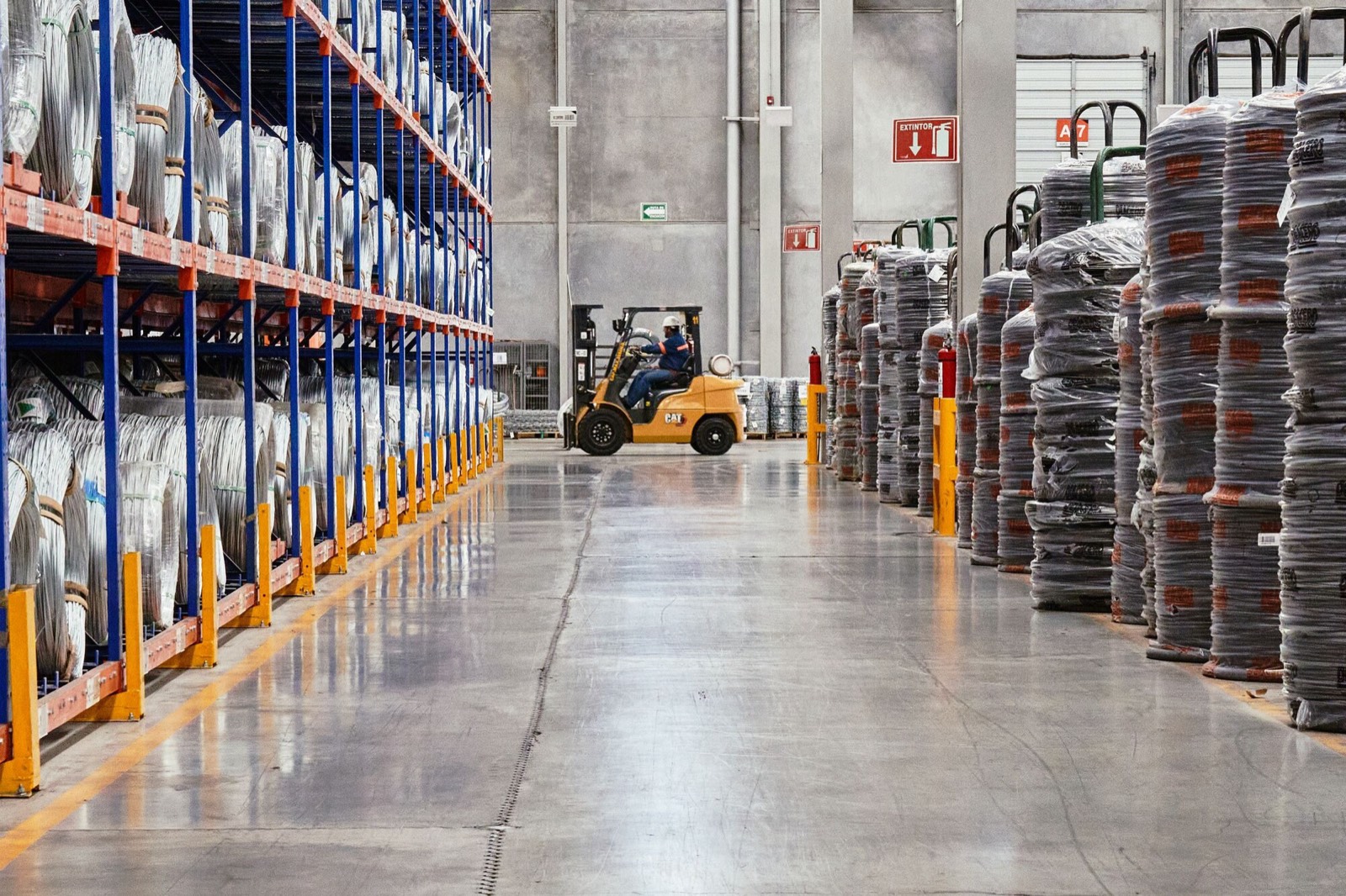 Warehouse aisle with a concrete floor and pallet racking