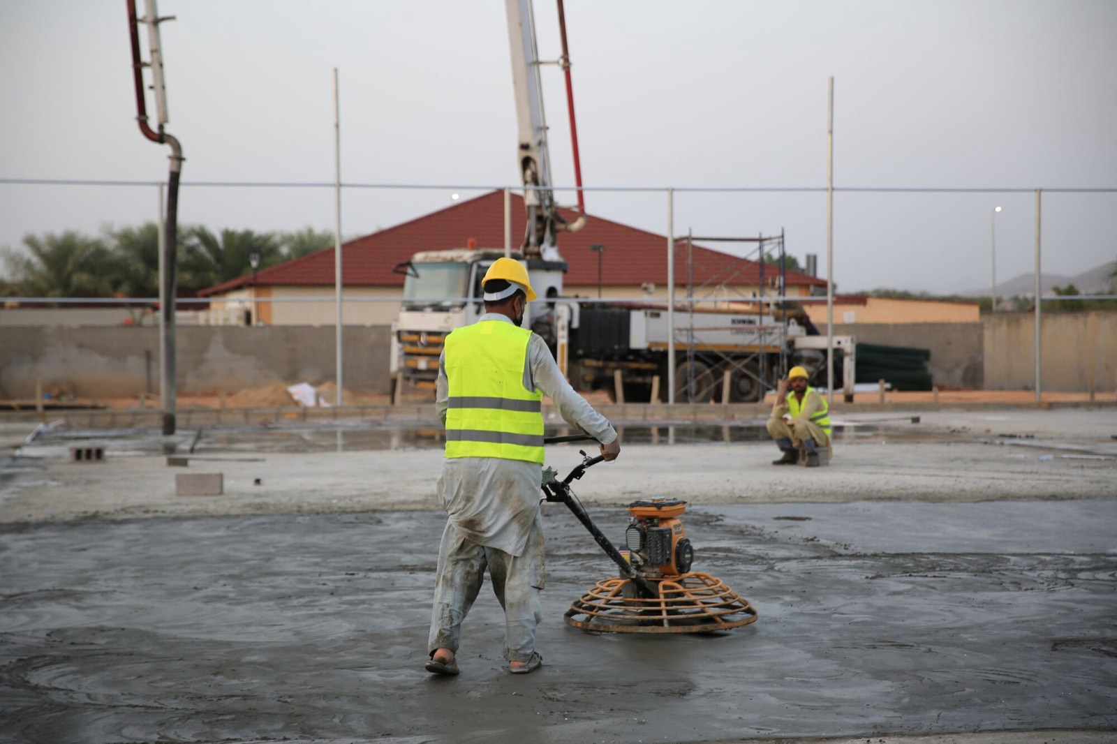 Power trowel finishing a concrete slab